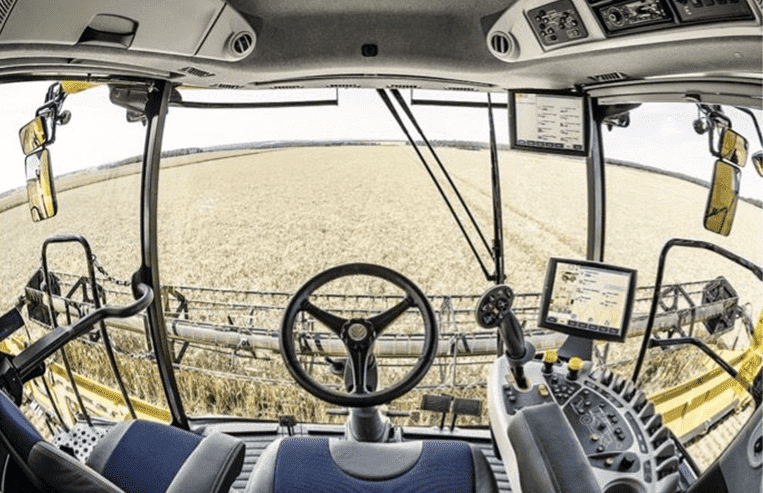 The inside of a combine is shown with a view directly onto the combine header.