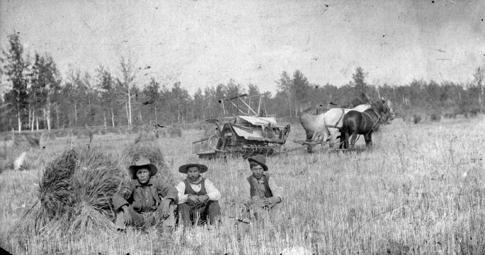A piece of art by Leah Marie Dorion made with mosaics shows two Indigenous people standing near animals, sun, and water. 