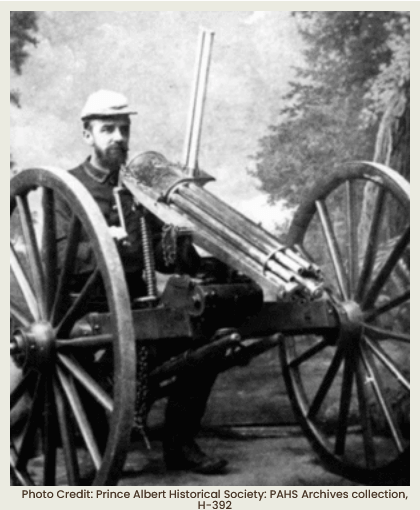 Photograph of pasta being made by putting dough through a hand-held pasta cutter.